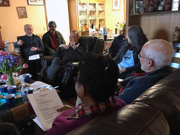 People having a conversation around a sitting room table